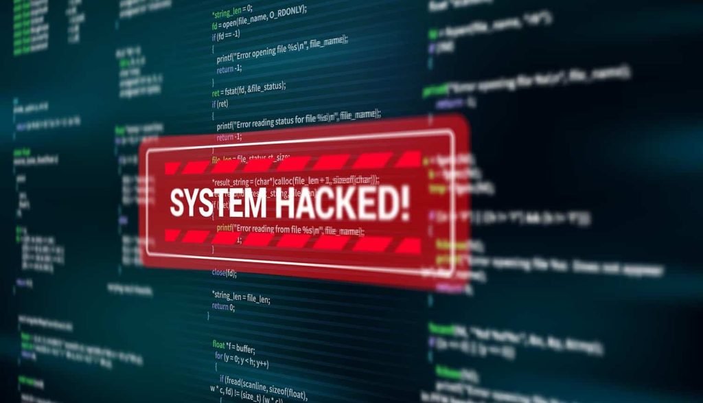 System hacked alert over computer code, illustrating the threat of cyber attacks and the need for cybersecurity measures.