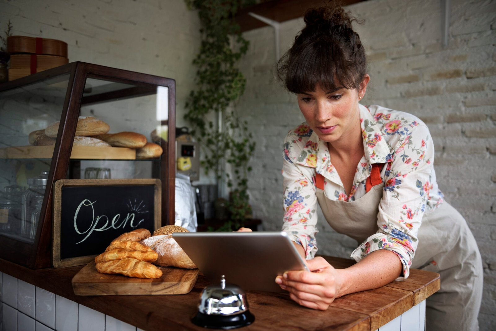 A small business owner using cloud-based software on a laptop